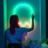 A person interacting with a neon ghost-shaped light. Produktbild-Vorschau