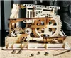 A wooden marble run model with several marbles scattered around it. Podgląd zdjęcia produktu
