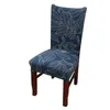A single chair with a blue leaf-patterned slipcover and wooden legs, isolated on a white background. Náhled obrázku produktu