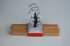 A set of wooden hangers with metal clips on a plain background. Produktbild-Vorschau