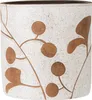 A close-up view of a decorative planter with a speckled white base and a brown botanical pattern. Produktbild-Vorschau