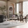 A stylish living room scene featuring a set of round coffee tables, chairs, and decorative elements. Voir les images du produit