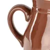 A close-up shot of the handle and side of a brown ceramic jar. Náhled obrázku produktu