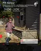 A child is running in a yard, with a security camera visible on the side of a house. Produktbild-Vorschau