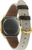 The back of a gold-toned digital watch with a fabric strap and leather accents. Voir les images du produit