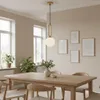 A dining room with a wooden table and chairs, illuminated by a pendant light. Produktbild-Vorschau