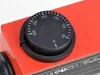 A close-up of a red device with a black temperature dial. Náhľad obrázku produktu