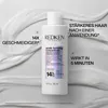 A bottle of Redken hair treatment product is shown with marketing text overlays. Produktbild-Vorschau