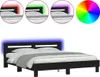 A black bed frame with blue LED lighting around the headboard, shown with bedding. Náhled obrázku produktu