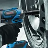 A person wearing black gloves is using a blue and black cordless impact wrench to tighten a lug nut on a car wheel. Voir les images du produit