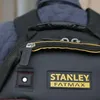 Close-up of a black Stanley FatMax backpack with yellow trim and branding. Voir les images du produit
