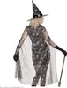 A woman wearing a witch costume, including a cape and hat, holding a cane. Anteprima dell’immagine prodotto