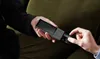 Two people are interacting with a portable translation device. Produktbild-Vorschau
