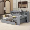 A modern gray daybed with integrated shelving and a pull-out drawer, set in a well-decorated room. Produktbild-Vorschau