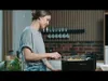 A woman is using a deep fryer in a kitchen. Produktbild-Vorschau