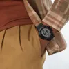 A close-up shot of a person's wrist wearing a digital watch. Voir les images du produit