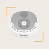 A top-down view of a white and gray baby sleep aid device with various buttons and a speaker grille. Náhľad obrázku produktu