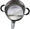 A stainless steel pot with black handles is shown, with water pouring out of its spout. Podgląd zdjęcia produktu