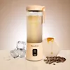 A portable blender with a beverage, ice cubes, coffee beans, and honey. Podgląd zdjęcia produktu