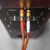 Close-up view of speaker cables plugged into the back of a speaker. Podgląd zdjęcia produktu
