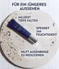 A NIVEA MEN anti-aging eye cream tube is shown on a textured surface with text overlays describing its benefits. Voir les images du produit
