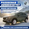 A car with snow chains on its tires in a snowy landscape. Produktbild-Vorschau