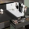 A close-up view of a vanity table with drawers open, showcasing various makeup and perfume bottles. Produktbild-Vorschau