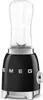 A black Smeg blender with a clear glass jar and silver accents, shown from a diagonal angle on a white background. Voir les images du produit