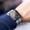A close-up shot of a person's wrist wearing a smartwatch with a blue case and a white and black perforated band. Produktbild-Vorschau