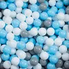 A pile of small, round balls in various shades of gray, white, and baby blue. Produktbild-Vorschau