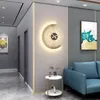 A modern hallway with a decorative wall clock and a small side table. Produktbild-Vorschau
