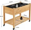 A wooden raised garden bed with a shelf and wheels, featuring dimensions and weight capacity labels. Podgląd zdjęcia produktu