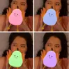 A collage of four images showing a person holding a pear-shaped LED night light in different colors. Produktbild-Vorschau