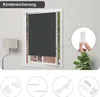 A dark grey roller blind is shown installed in a white window frame. The image also includes inset circles showing installation accessories and a close-up of a child safety mechanism. Produktbild-Vorschau