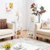 Two white nightstands with drawers are placed next to cream-colored armchairs in a well-lit living room. Podgląd zdjęcia produktu