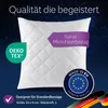A white quilted pillow against a dark blue starry background, with marketing overlays and logos. Produktbild-Vorschau