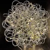 A silver, tangled wire sphere with embedded lights against a black background. Produktbild-Vorschau