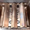 A close-up, overhead view of four stainless steel heat plates inside a grill. Podgląd zdjęcia produktu