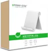The image shows the retail packaging of a Ugreen adjustable portable stand for phones and tablets. Náhľad obrázku produktu