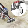 A close-up of a vacuum cleaner head on a fluffy rug, with an inset showing dust being collected in the vacuum's bin. Produktbild-Vorschau