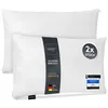 Two white pillows are shown, one slightly behind the other. A dark band with branding and product information is wrapped around the front pillow. Produktbild-Vorschau
