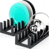 Two black dish racks, one holding turquoise, gray, and black plates, and the other holding pot lids. Náhled obrázku produktu