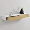 A white and wood-tone floating shelf with one drawer partially open, mounted on a light gray wall. A black vase with white flowers and two small decorative picture frames are on the shelf. Náhľad obrázku produktu