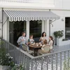 A family enjoys coffee on a balcony under a striped awning. Náhled obrázku produktu