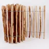 A close-up view of a wooden fence made of hazelnut sticks bound together with wire. Voir les images du produit
