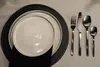A table setting with plates and cutlery. Náhľad obrázku produktu