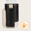 A close-up of a bottle warmer with a black leather-like cover and a beige base, next to a battery icon indicating 9 hours of use. Produktbild-Vorschau
