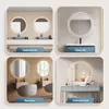 A collage of four different bathroom and vanity settings, each featuring a round mirror with integrated lighting. Voir les images du produit