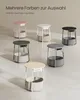 A collection of modern side tables in various colors, displayed on a neutral floor. Produktbild-Vorschau
