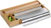 A wooden organizer for kitchen foil, plastic wrap, and parchment paper, with green clips in a separate compartment. Produktbild-Vorschau